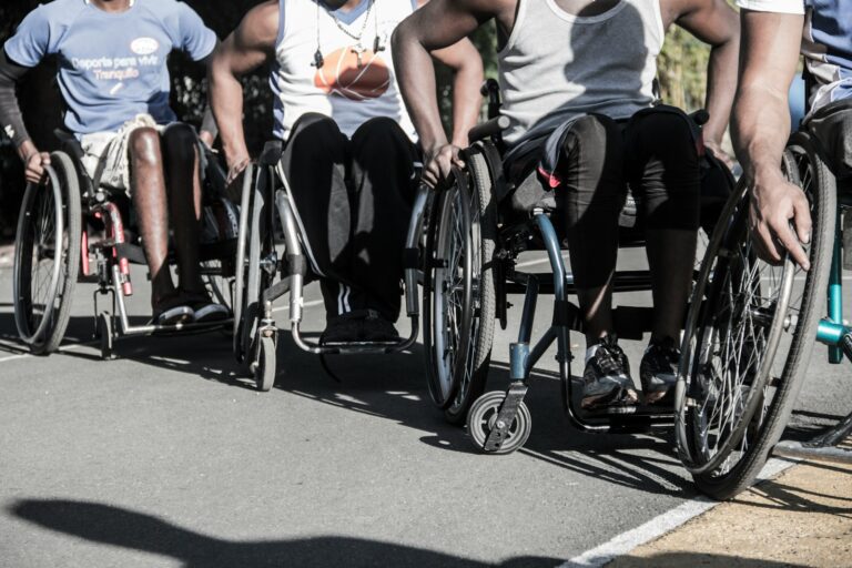 A group of men riding bikes down a street